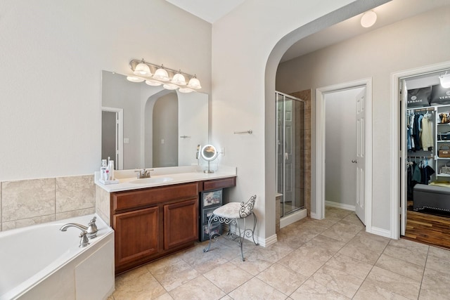 bathroom featuring vanity and separate shower and tub