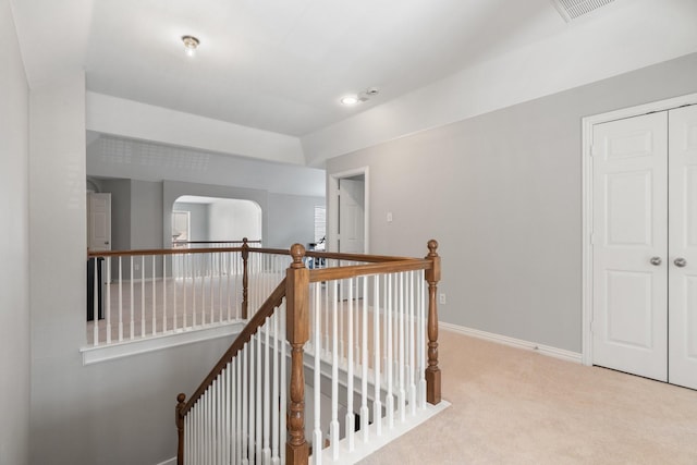 hallway featuring light carpet