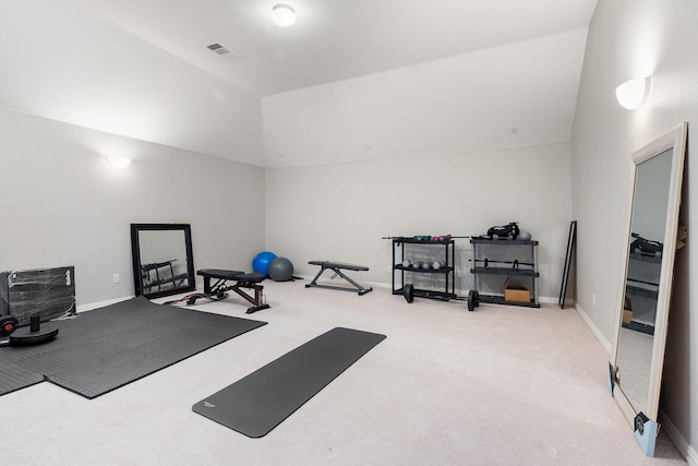 workout room featuring vaulted ceiling and carpet floors