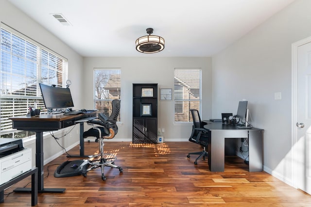 office space featuring plenty of natural light and hardwood / wood-style floors