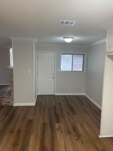 entrance foyer with dark hardwood / wood-style flooring and ornamental molding