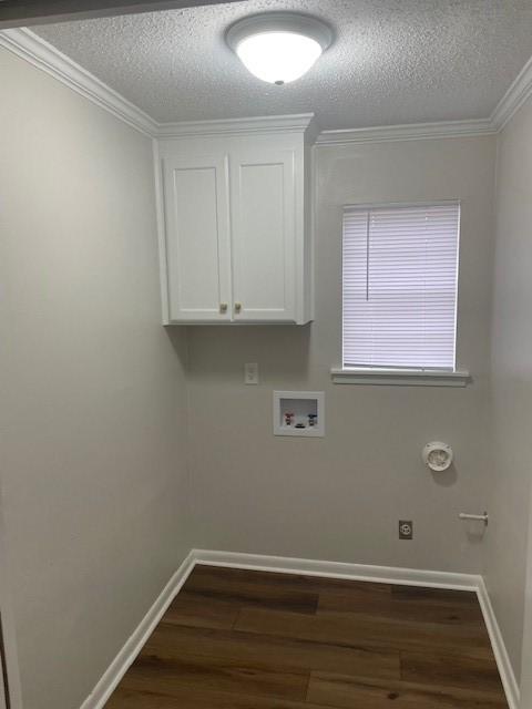 laundry room with dark hardwood / wood-style floors, cabinets, washer hookup, crown molding, and a textured ceiling