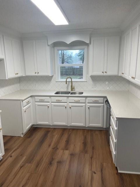 kitchen featuring dark hardwood / wood-style flooring, sink, decorative backsplash, and white cabinets