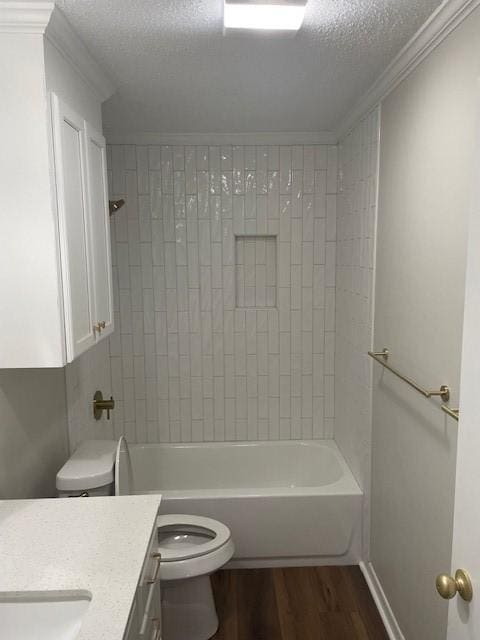 full bathroom featuring vanity, hardwood / wood-style flooring, a textured ceiling, and toilet