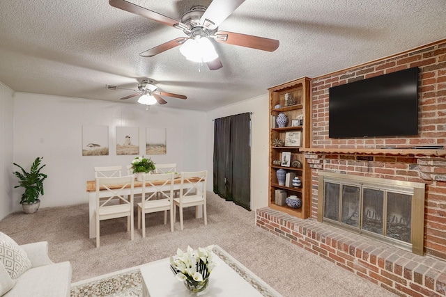 carpeted living room with a fireplace and a textured ceiling