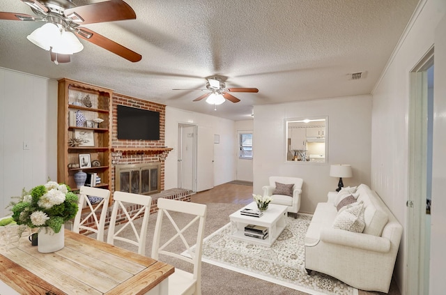 living room featuring a textured ceiling and a fireplace