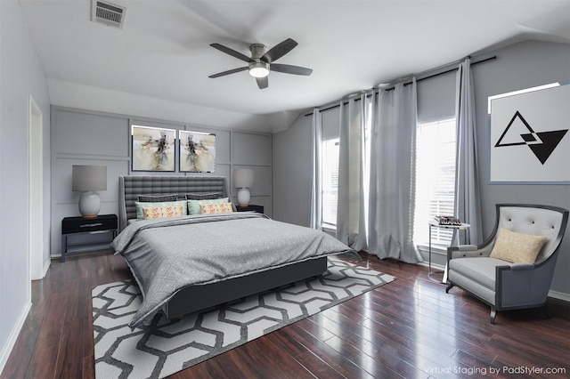 bedroom with a ceiling fan, visible vents, dark wood finished floors, and baseboards