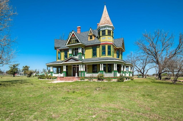 victorian home featuring covered porch and a front yard