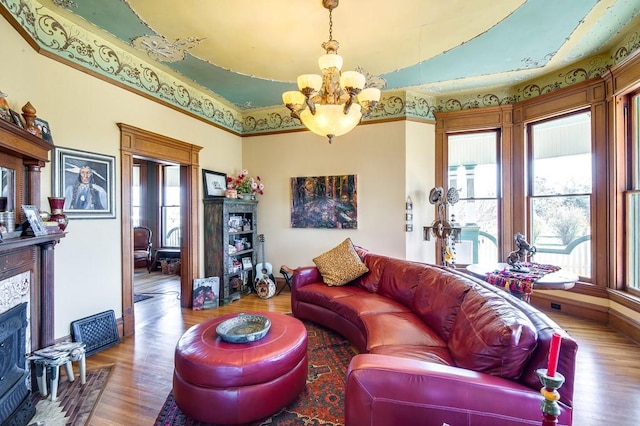 living room featuring hardwood / wood-style flooring and an inviting chandelier