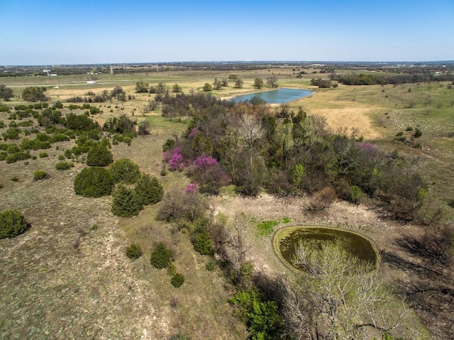 birds eye view of property with a rural view and a water view