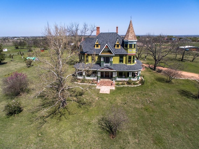 view of front of property featuring covered porch and a front yard