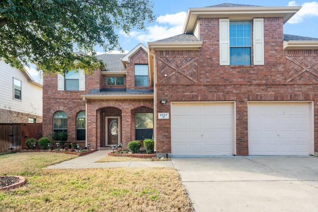 view of front of property with a garage and a front yard