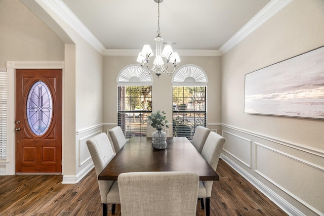 dining space featuring crown molding, dark hardwood / wood-style flooring, and a chandelier