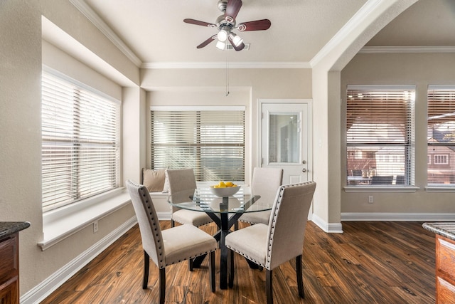 dining space with crown molding, ceiling fan, and dark hardwood / wood-style floors