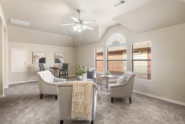 carpeted living room with ceiling fan and lofted ceiling