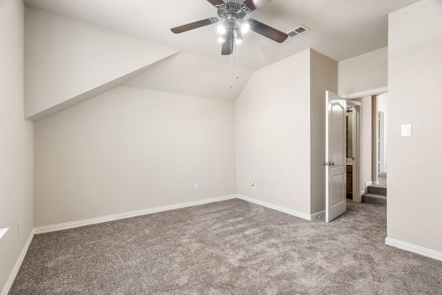 additional living space featuring lofted ceiling, light carpet, and ceiling fan