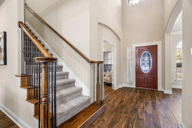 entrance foyer with dark wood-type flooring and a high ceiling