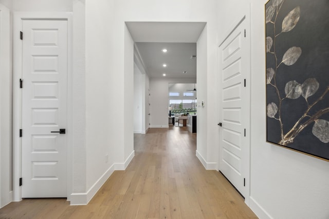 hallway with light hardwood / wood-style floors