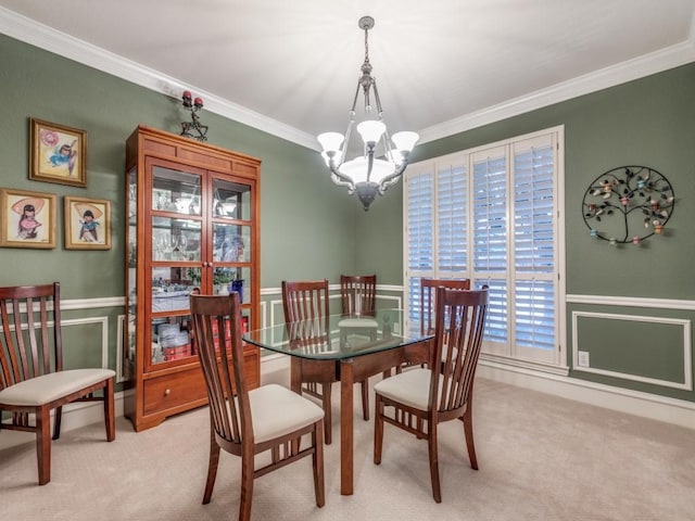 carpeted dining space featuring ornamental molding and an inviting chandelier