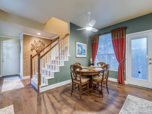 dining area featuring stairs, ceiling fan, wood finished floors, and baseboards