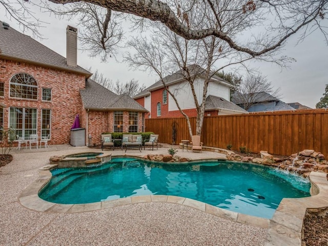 view of swimming pool featuring a patio area, a pool with connected hot tub, fence, and an outdoor hangout area