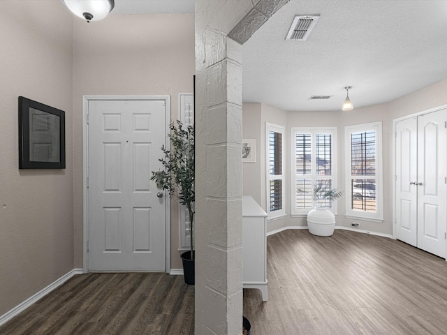 entrance foyer featuring dark hardwood / wood-style floors and a textured ceiling