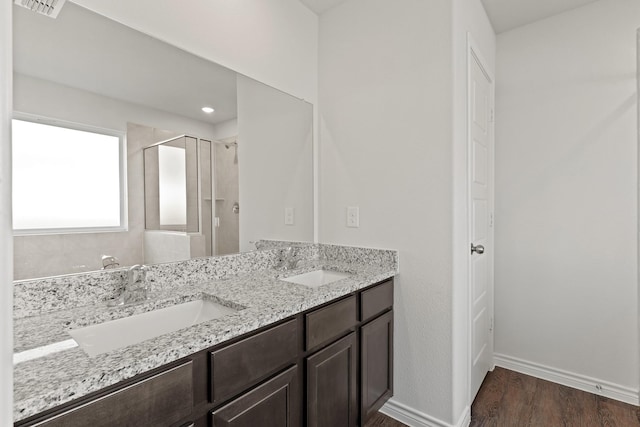 2413 Dahlia Dr, Fort Worth, TX 76123 - bathroom featuring a shower stall, wood finished floors, baseboards, and double vanity