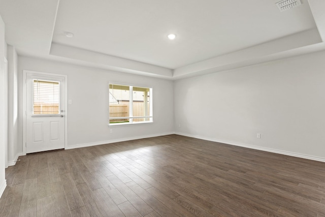 2413 Dahlia Dr, Fort Worth, TX 76123 - unfurnished room with a raised ceiling, plenty of natural light, dark wood-type flooring, and recessed lighting