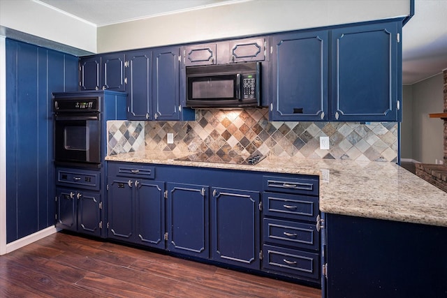 kitchen featuring light stone counters, black appliances, and blue cabinetry