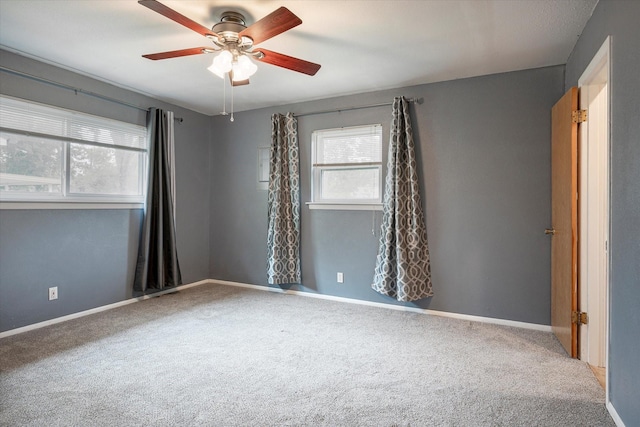 empty room with carpet flooring and ceiling fan