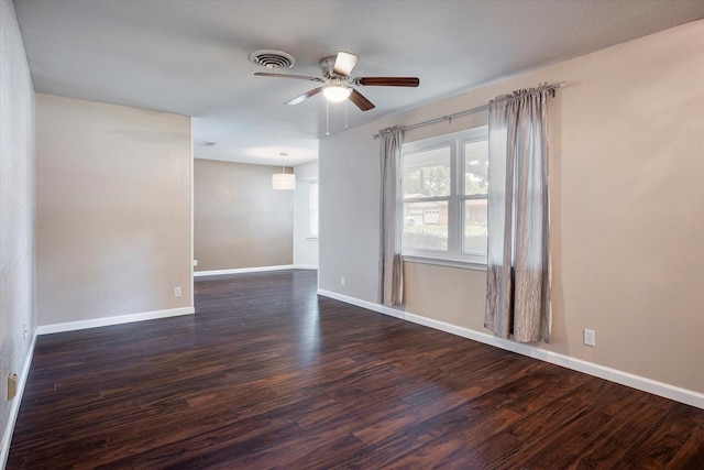 empty room with ceiling fan and dark hardwood / wood-style floors