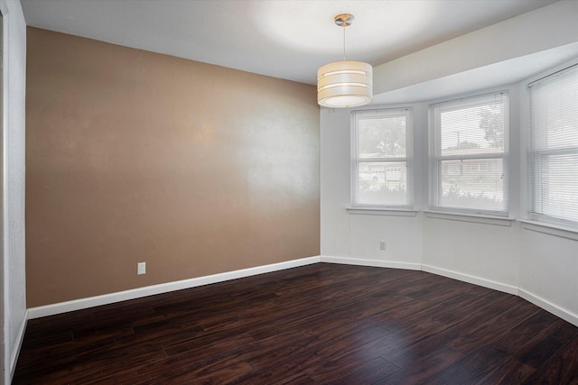 empty room with dark hardwood / wood-style floors