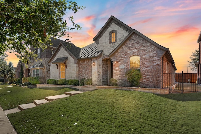 french country home with a lawn