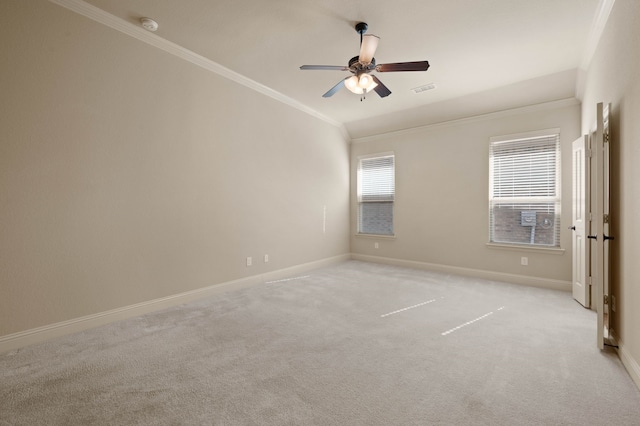 carpeted empty room featuring crown molding, a healthy amount of sunlight, and ceiling fan