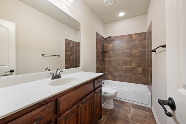 full bathroom with vanity, tiled shower / bath, tile patterned floors, and toilet