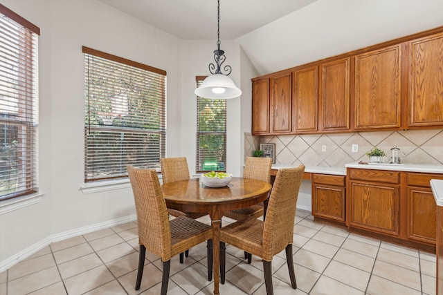 dining room featuring lofted ceiling and light tile patterned floors