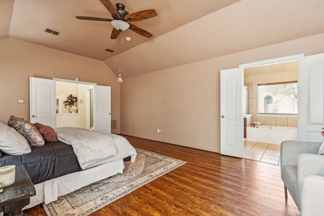 bedroom featuring hardwood / wood-style flooring, ensuite bathroom, lofted ceiling, and ceiling fan