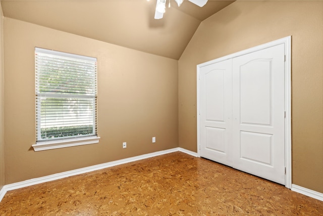 unfurnished bedroom with vaulted ceiling, ceiling fan, and a closet