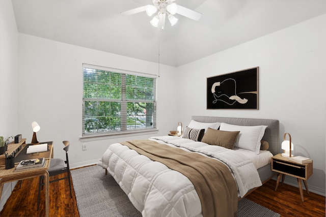 bedroom featuring lofted ceiling, dark hardwood / wood-style floors, and ceiling fan