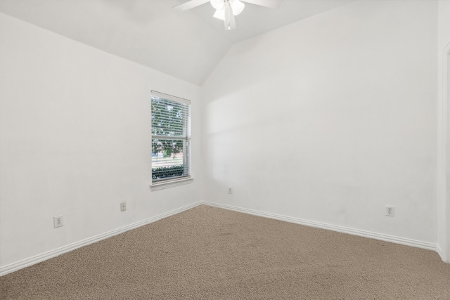 spare room with lofted ceiling, ceiling fan, and carpet flooring