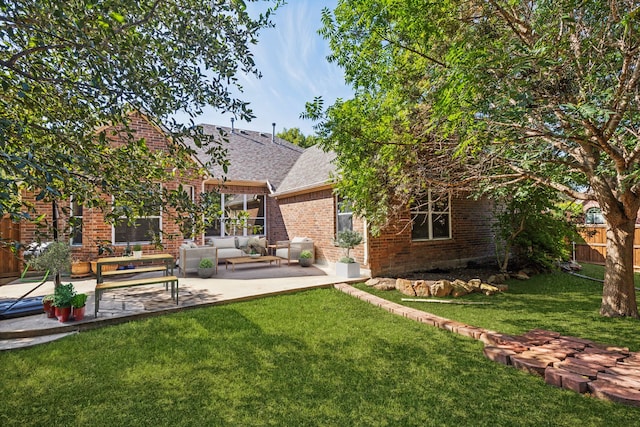 rear view of house featuring an outdoor living space, a yard, and a patio