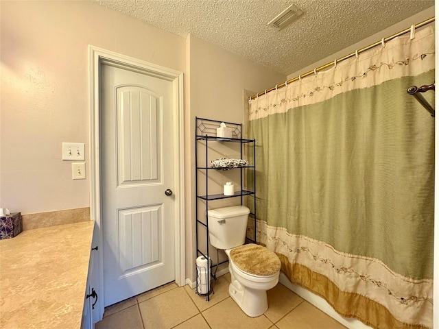 full bathroom featuring shower / tub combo, vanity, a textured ceiling, tile patterned floors, and toilet