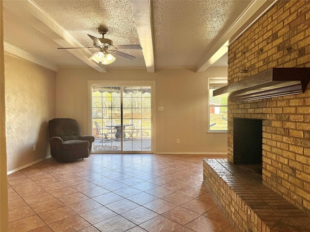 unfurnished living room featuring ceiling fan, beam ceiling, a textured ceiling, light tile patterned flooring, and a brick fireplace