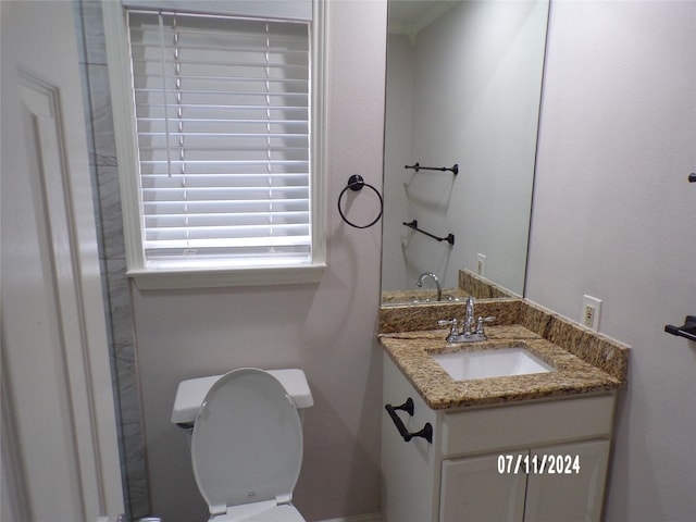 bathroom featuring vanity and toilet