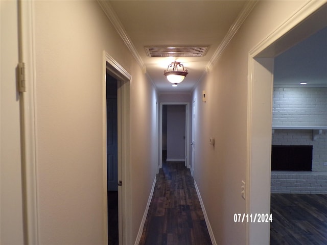 corridor featuring crown molding and dark hardwood / wood-style floors