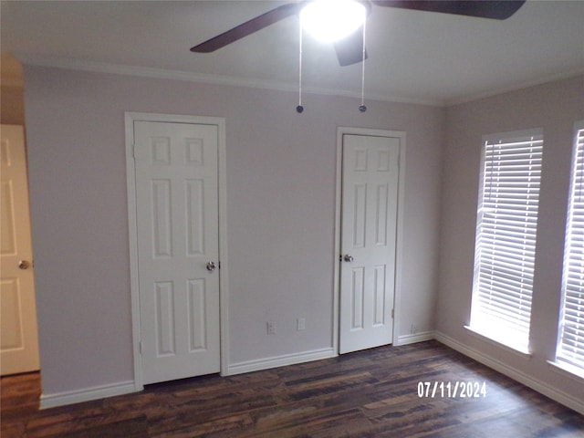 unfurnished bedroom featuring ornamental molding, dark wood-type flooring, and ceiling fan