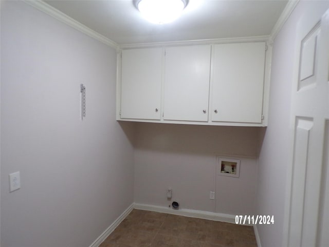 laundry room featuring washer hookup, crown molding, and cabinets