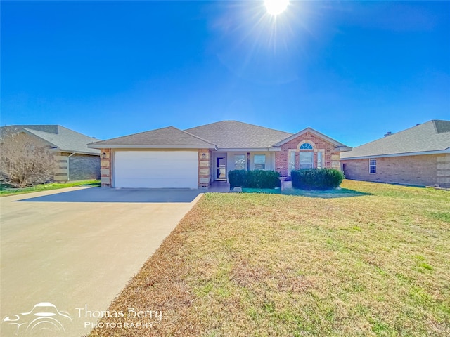 ranch-style home with a garage and a front yard