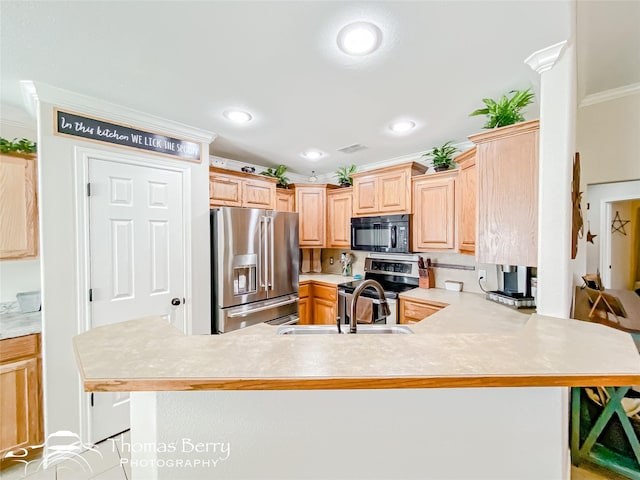 kitchen featuring stainless steel appliances, kitchen peninsula, sink, and light brown cabinets