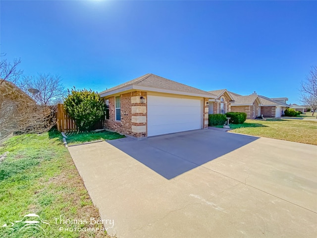 ranch-style home with a garage and a front yard